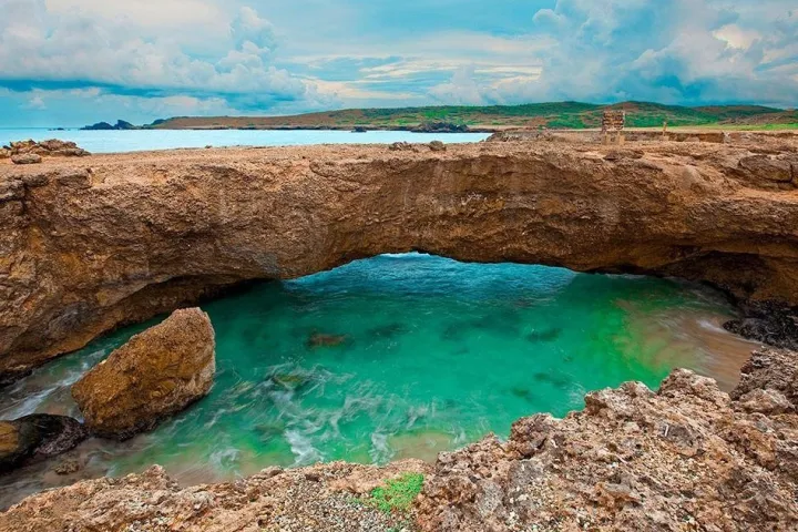 a rocky beach next to the water