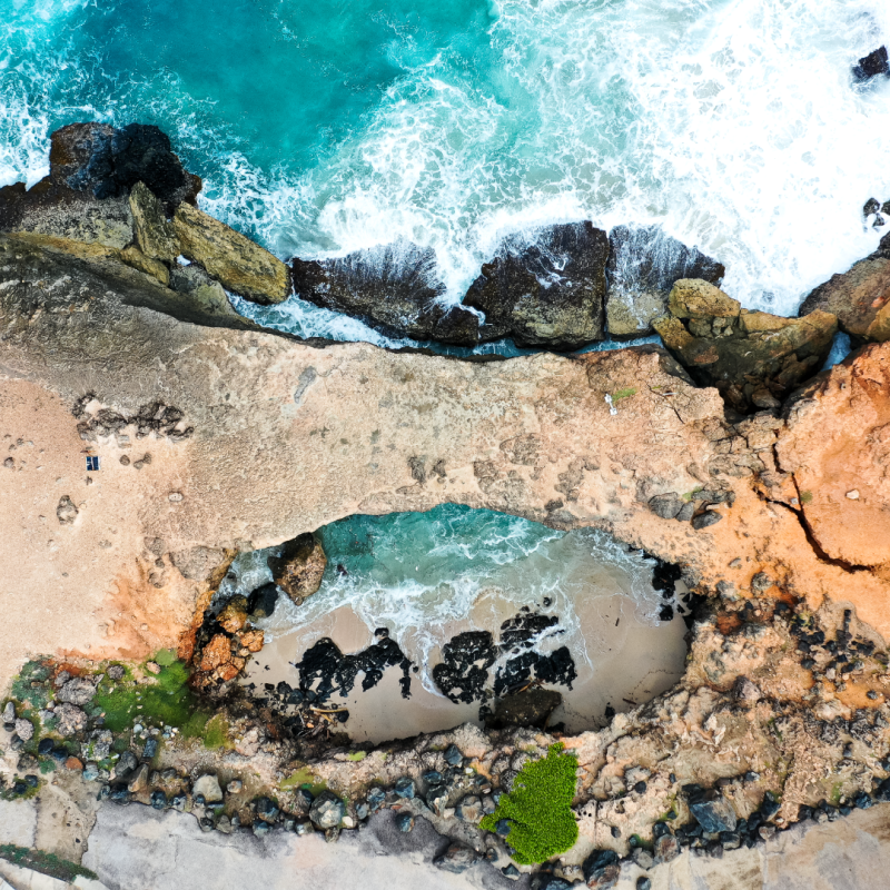 a close up of a rock near the ocean