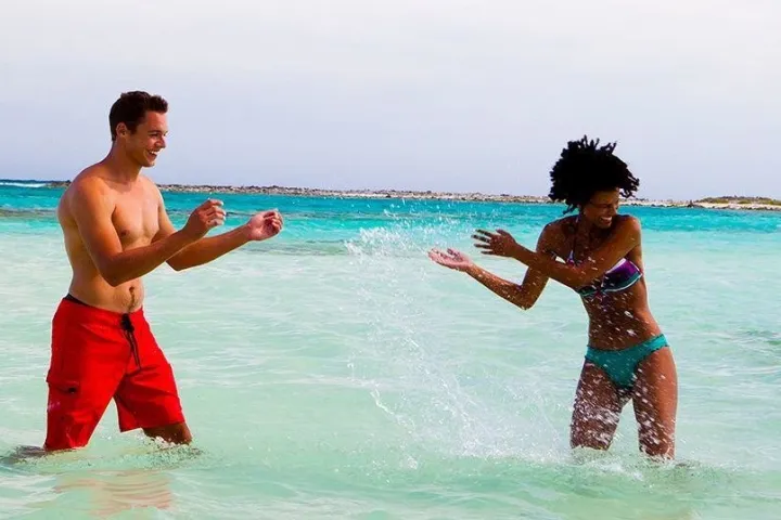 a man throwing a frisbee in a body of water