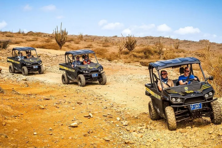 a car parked on the side of a dirt field