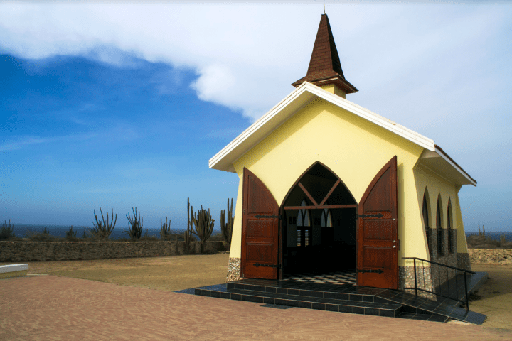 a clock tower in front of a house