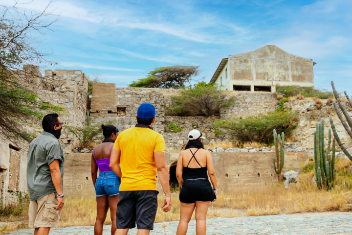 a group of people walking down a dirt road