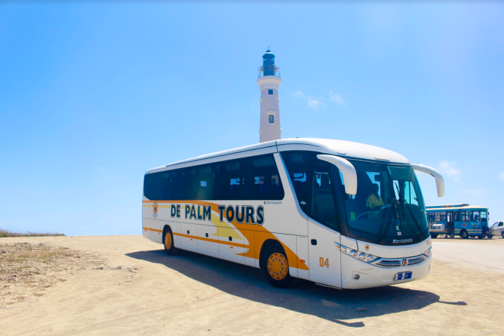 a blue bus parked on the side of a road