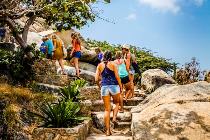 a man and a woman standing on a rock
