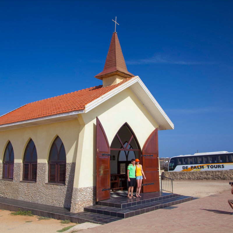 a small clock tower in front of a building