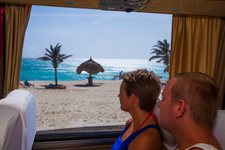 a group of people sitting at a beach