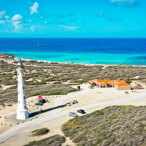 a group of lawn chairs sitting on top of a sandy beach