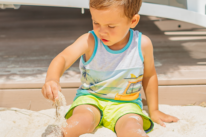 a little boy sitting at De Palm Island