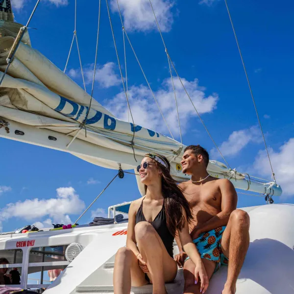 a man and a woman sitting on a swing