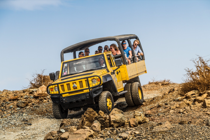 a truck driving down a dirt road