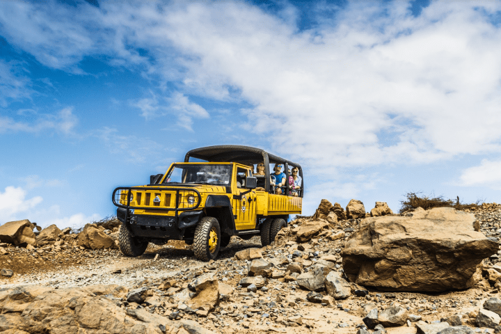 a truck driving down a dirt road