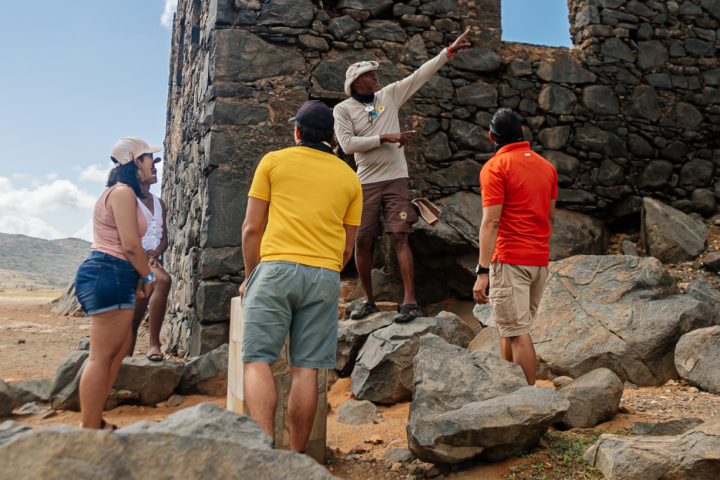 a group of people on a rock wall