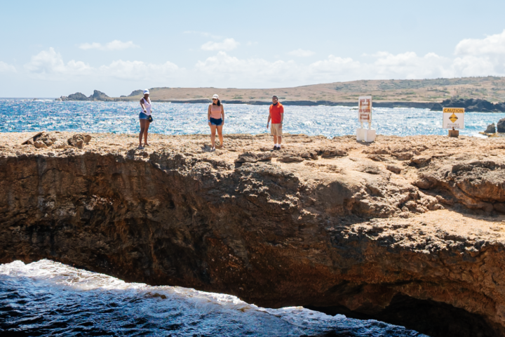 a man standing on a rocky beach