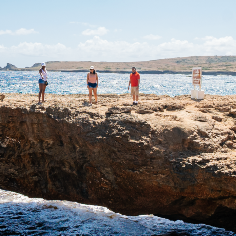 a man standing on a rocky beach