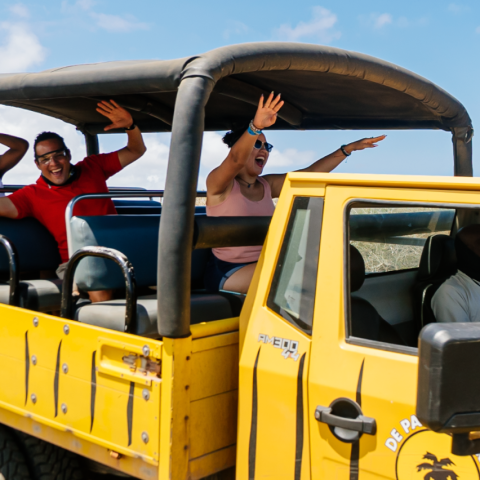 a group of people riding on the back of a truck