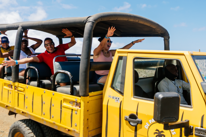 a group of people riding on the back of a truck
