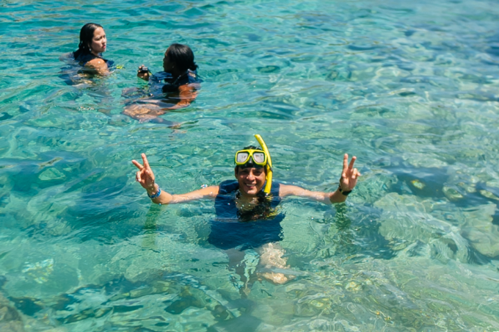 a group of people swimming in a pool of water