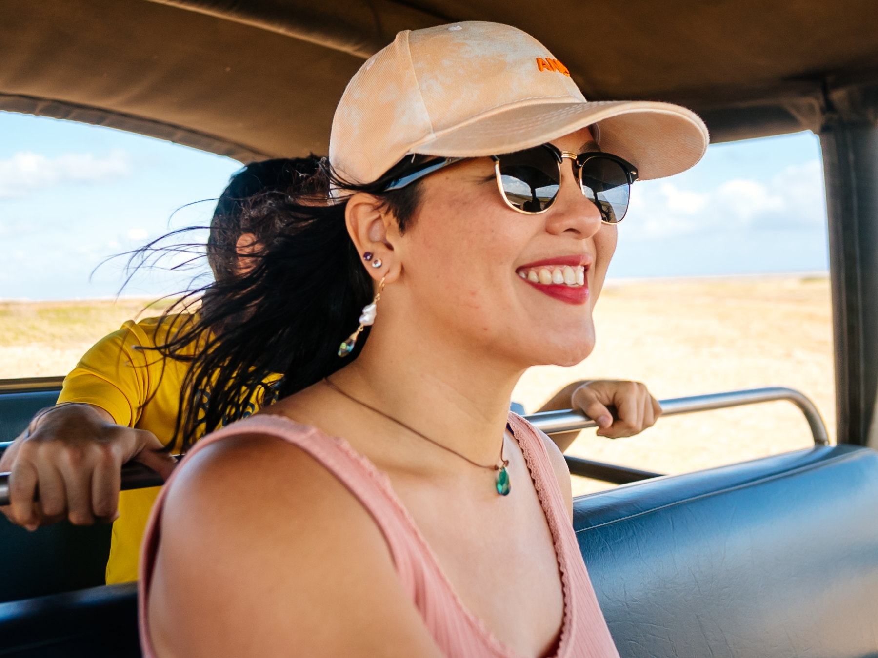 a woman wearing sunglasses driving a car