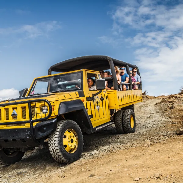 a truck driving down a dirt road