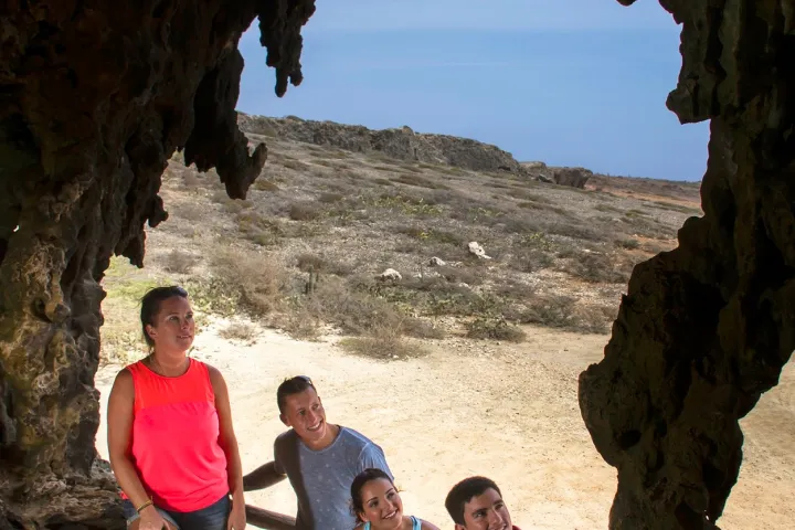 a group of people standing in a rocky area