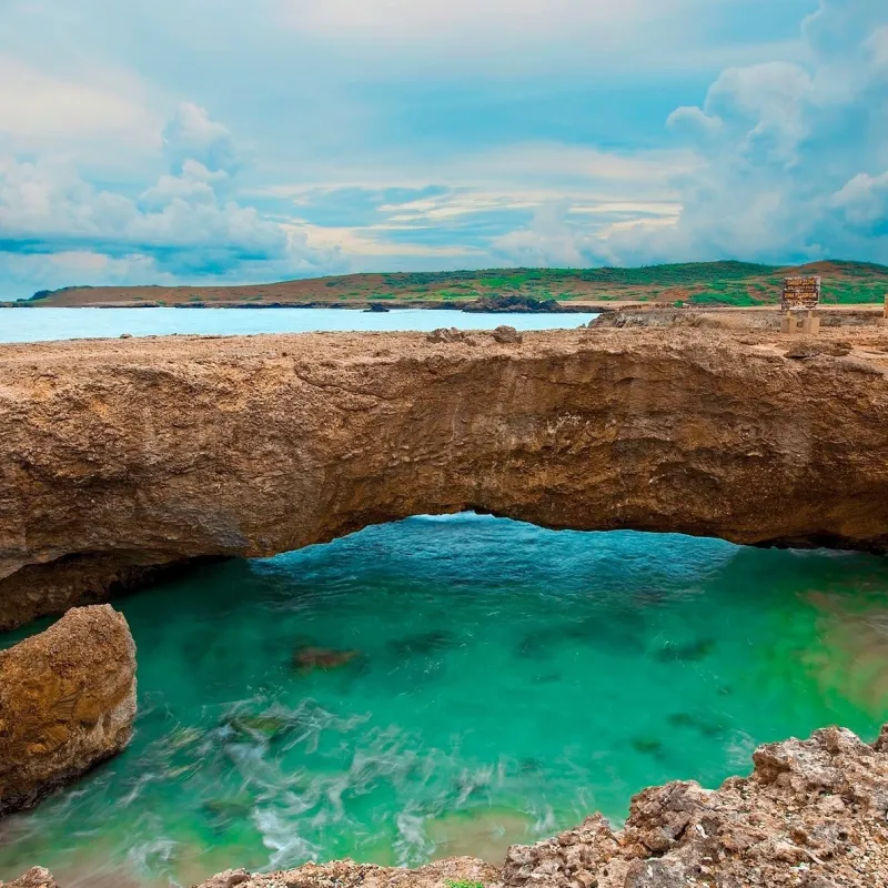 a rocky beach next to a body of water
