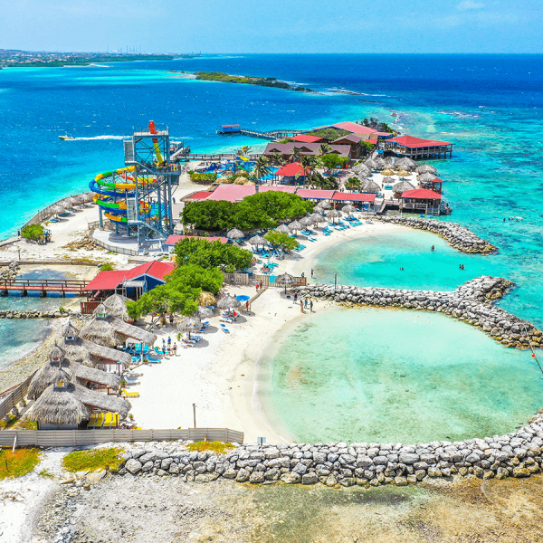 a group of people on a beach near a body of water