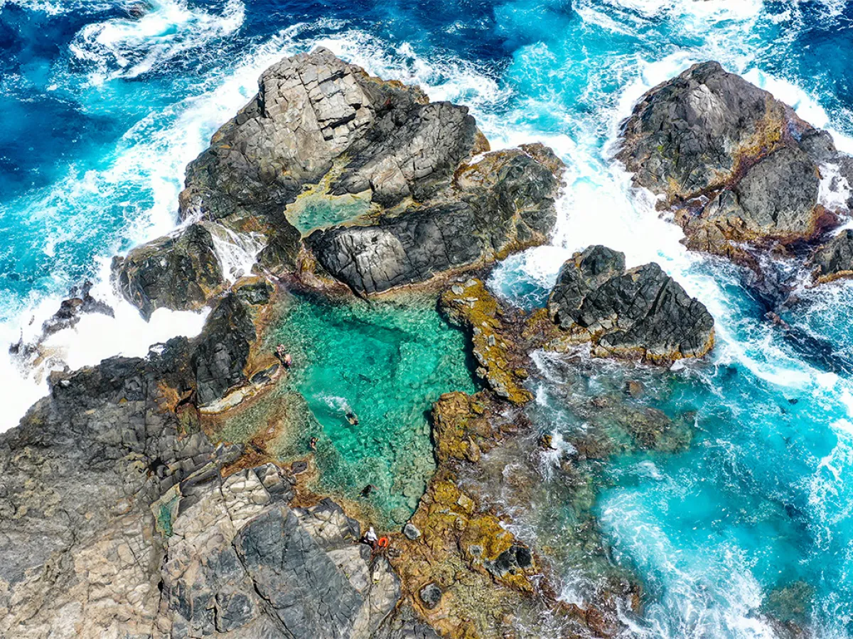 a large waterfall over some water
