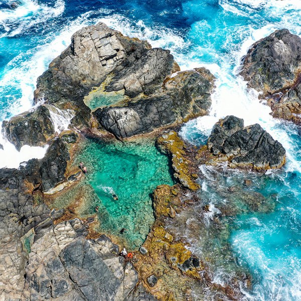 a large waterfall over some water