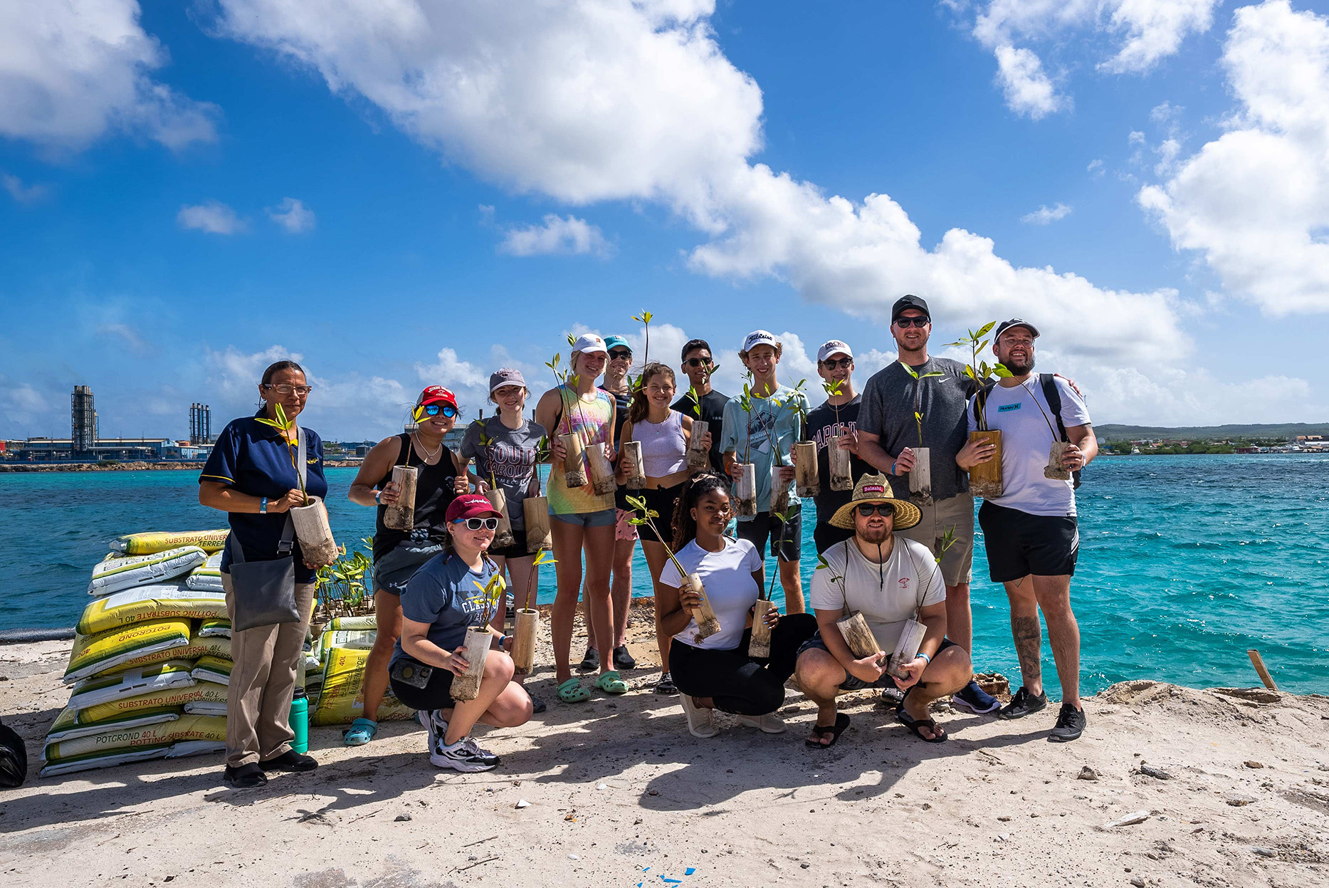 student planting mangroves at de palm island