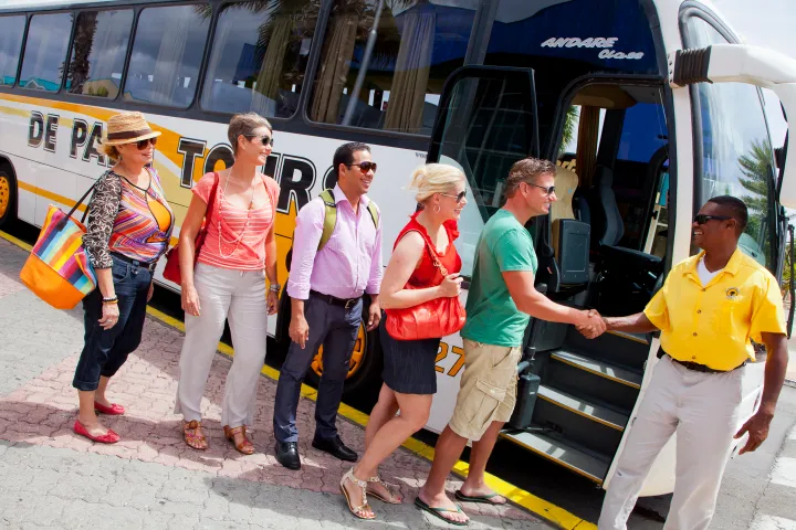 a group of people standing around a bus