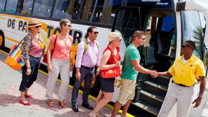 a group of people standing around a bus