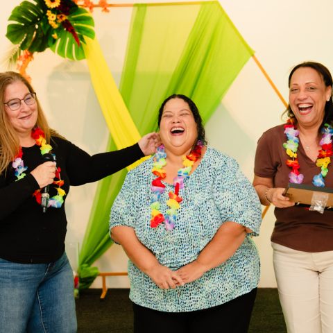 a person standing in front of a group of people posing for the camera