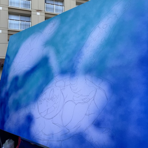 Partially painted canvas with outlines of sea turtles in blue and turquoise.