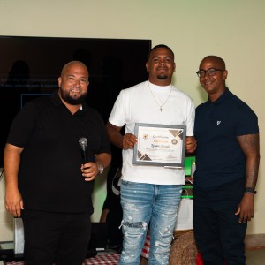 Three men smiling; one holds a certificate.